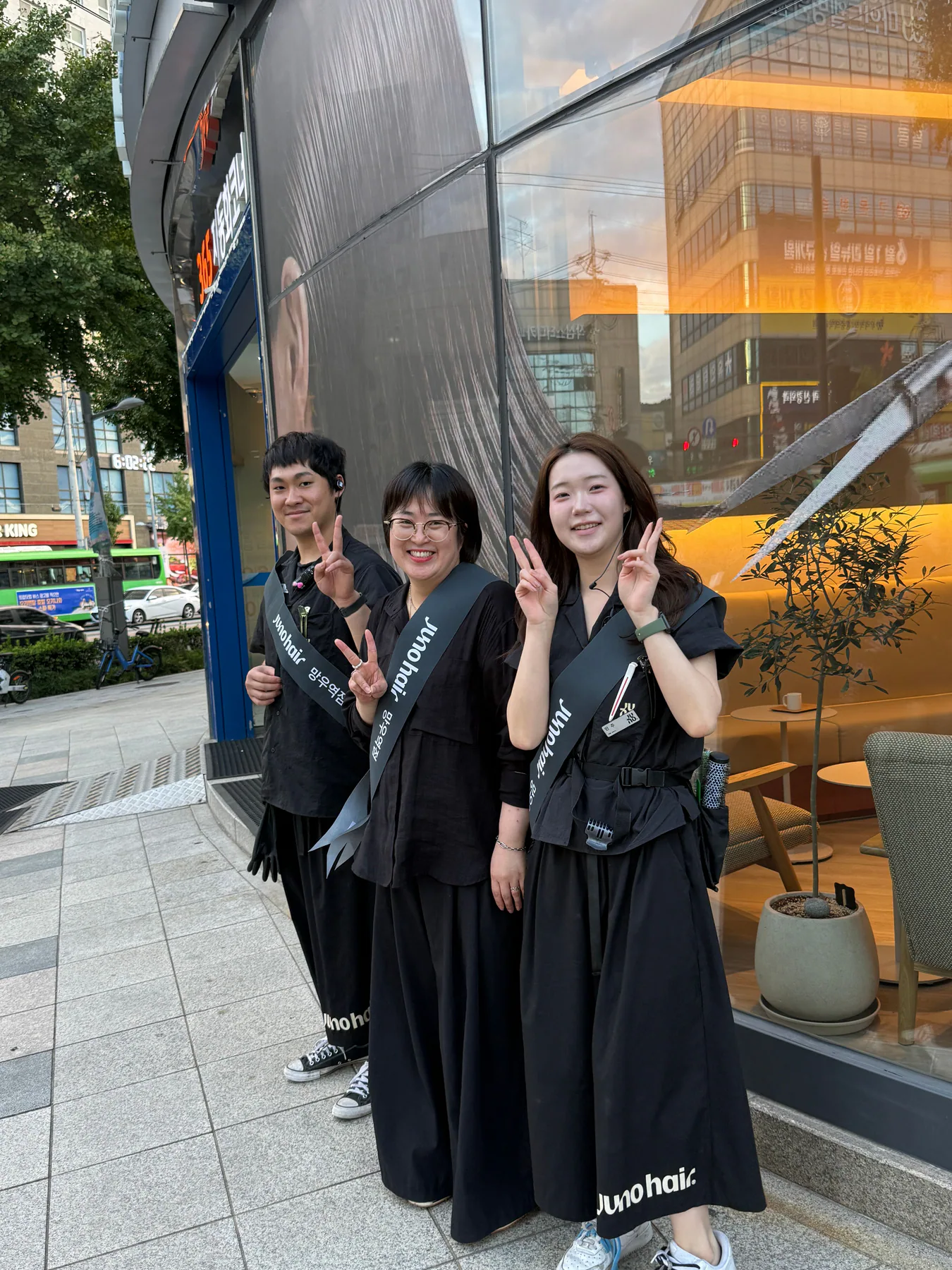 The JUNO HAIR Mangu Station team greeting in front of the salon